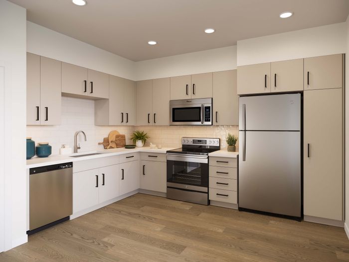 Sleek modern kitchen with stainless steel appliances, light cabinetry, and wood flooring, optimized for style and functionality.