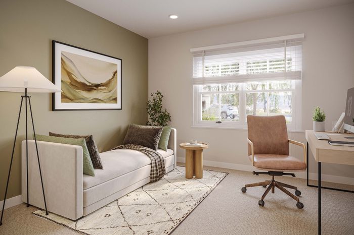 Chic home office with a cozy daybed, modern desk setup, and natural light streaming in through large windows.