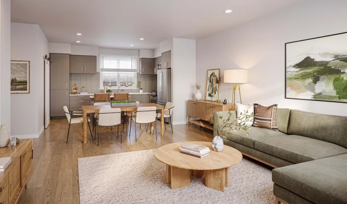 Chic open-plan living space with a modern kitchen, cozy dining area, and elegant living room area featuring stylish decor and ample natural light.