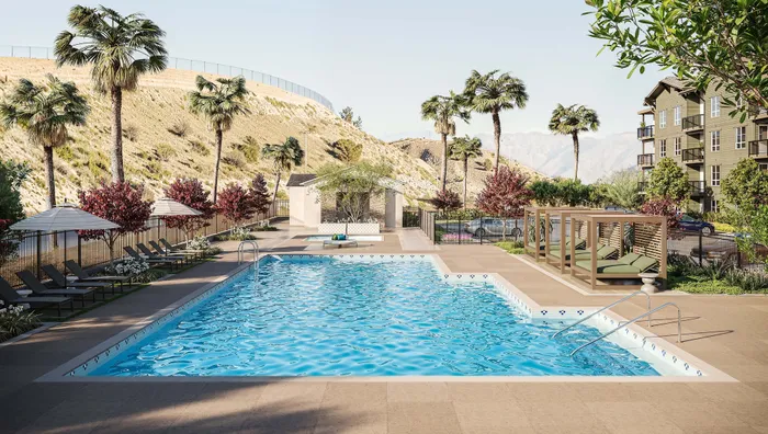 Outdoor pool area with sun loungers and palm trees, offering a serene oasis against a backdrop of rolling hills.