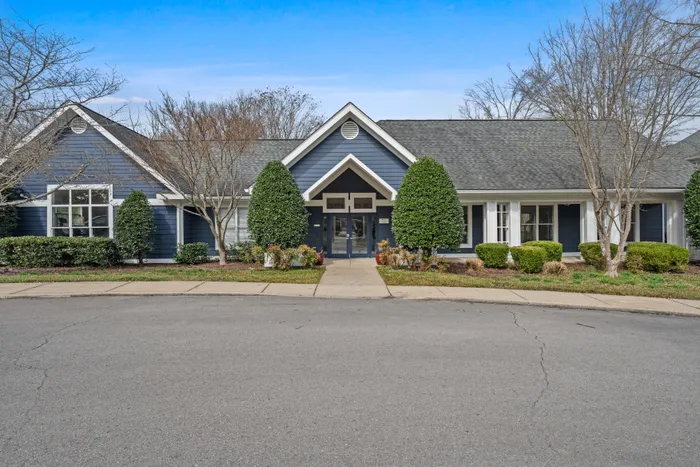 Elegant blue house with charming landscaping and inviting entrance, perfect for modern living.