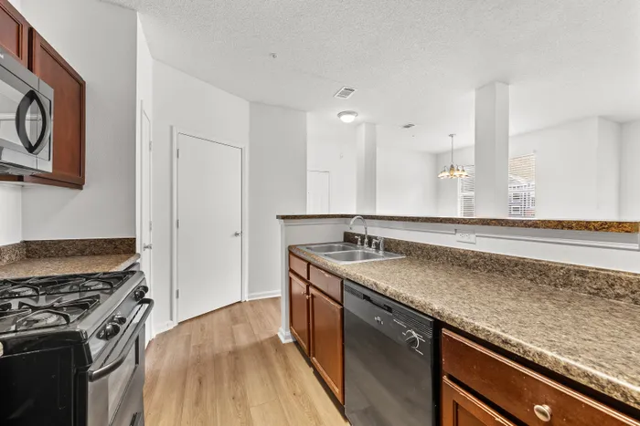 Modern kitchen with sleek countertops, stainless steel appliances, and ample natural light.