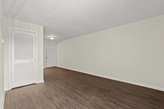 Bright and inviting entryway with elegant wood flooring and modern white trim, perfect for a welcoming atmosphere.