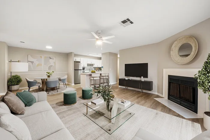 Modern living area featuring an elegant open-concept design with cozy seating, stylish decor, and a sleek kitchen bar.