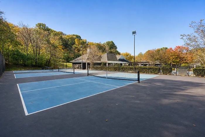 Inviting tennis courts set amidst vibrant autumn foliage, offering a perfect blend of outdoor recreation and scenic beauty.