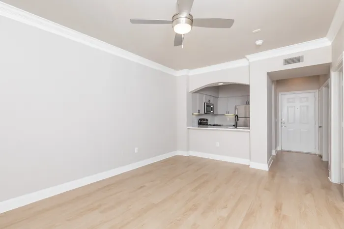 Bright, contemporary living space with sleek wood flooring and modern open kitchen perfect for entertaining.