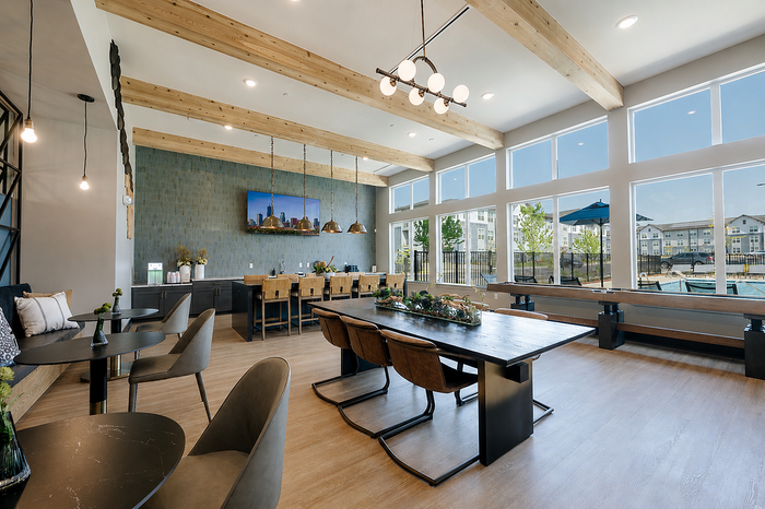 Inviting modern dining area with large windows, stylish seating, and scenic outdoor views.