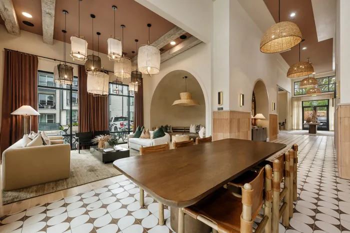Luxurious open-concept living area with contemporary design, stylish pendant lighting, and large windows offering abundant natural light.