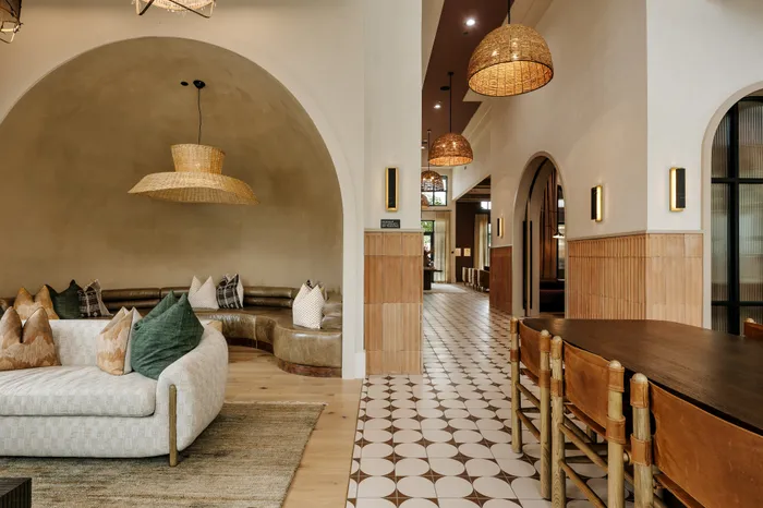 Elegant living area with plush seating, artistic lighting, and stylish tile flooring in a modern apartment.
