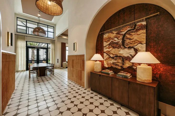 Luxurious interior featuring a grand entrance with stylish tile flooring, elegant dining area, and artistic wall decor for a sophisticated ambiance.