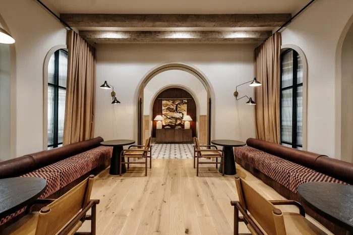 Inviting lounge area with cozy seating, stylish lighting, and elegant wood flooring, perfect for relaxation and socializing.
