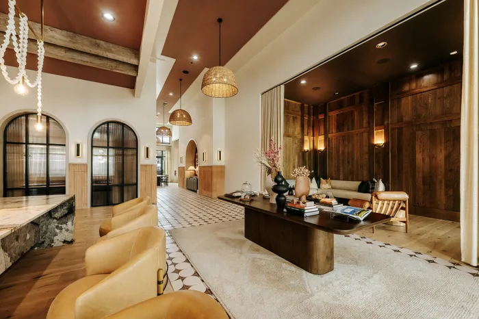 Inviting and stylish living space featuring elegant leather seating, warm wood accents, and soft lighting for a cozy ambiance.
