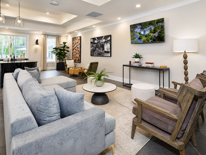 Elegant and modern living room with plush seating, stylish decor, and natural light highlighting contemporary art.