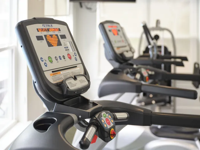 Modern apartment gym with state-of-the-art treadmills, bright and inviting workout space.