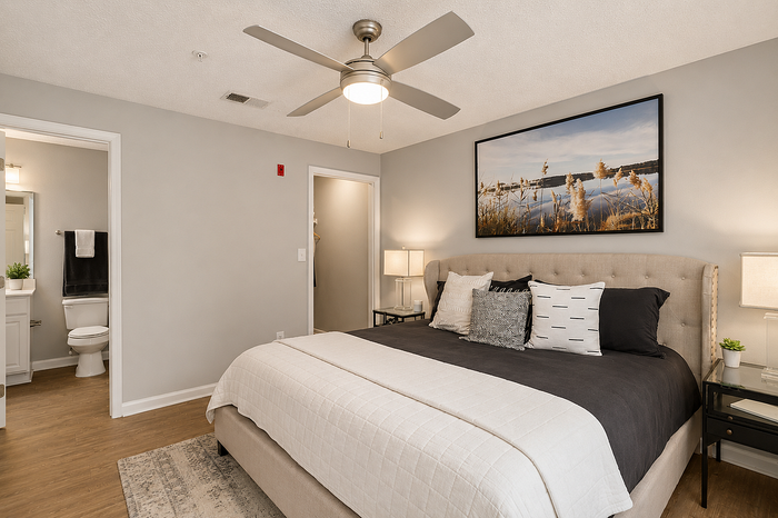 Inviting bedroom retreat with plush bedding, elegant decor, and soft ambient lighting, featuring an en-suite bathroom for ultimate convenience.