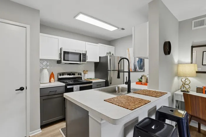 Modern kitchen with sleek appliances, stylish cabinetry, and a cozy breakfast bar.