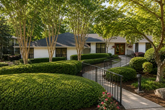 Charming residential home with lush landscaped garden, mature trees, and inviting entrance pathway.