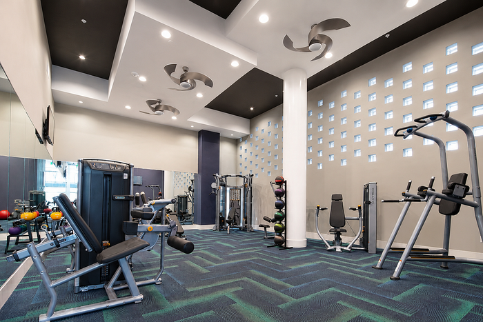 Modern fitness center with state-of-the-art equipment, sleek design, and vibrant lighting.