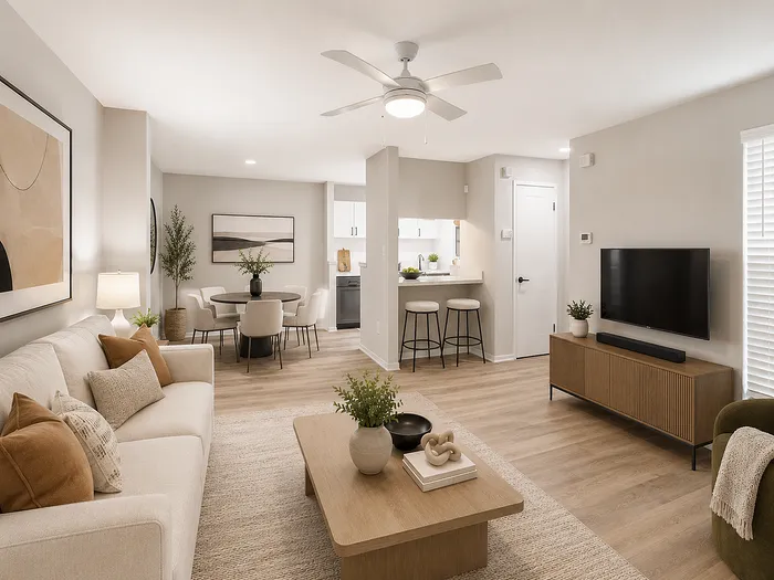 Modern living space featuring elegant decor, cozy seating, a dining area with chic chairs, and a stylish open kitchen with breakfast bar.