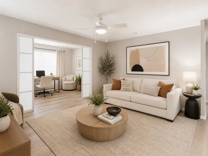 Elegant living room with modern decor, plush seating, and a serene home office with natural light and greenery.