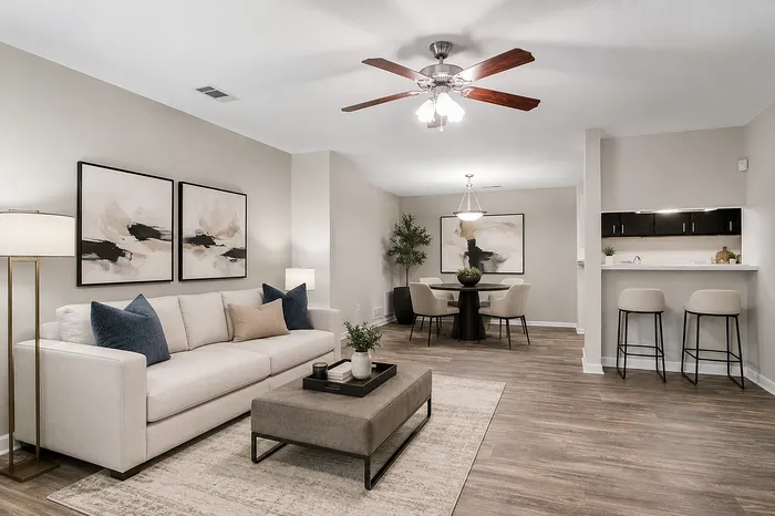Modern open-concept living space boasting elegant decor, a cozy sofa, and a stylish breakfast bar.