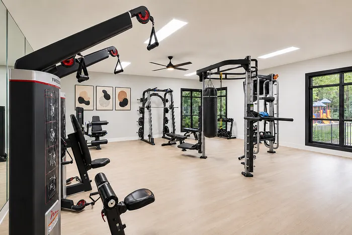 Modern and spacious apartment gym with state-of-the-art equipment, bright natural lighting, and elegant decor.