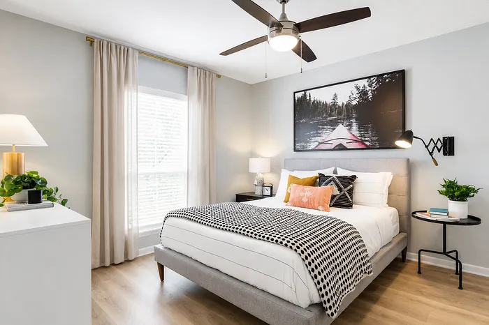 Bright, cozy modern bedroom filled with natural light, stylish decor, and a spacious layout at Avana Cumberland.