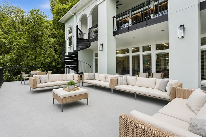 Elegant outdoor lounge terrace with stylish rattan furniture and stunning Chattahoochee River views at Avana Cumberland.
