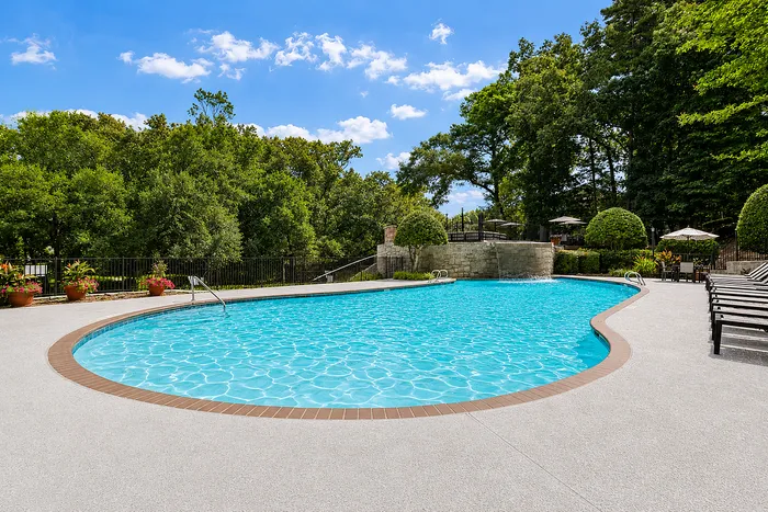 Swimming pool surrounded by greenery at Avana Cumberland in Atlanta, GA.