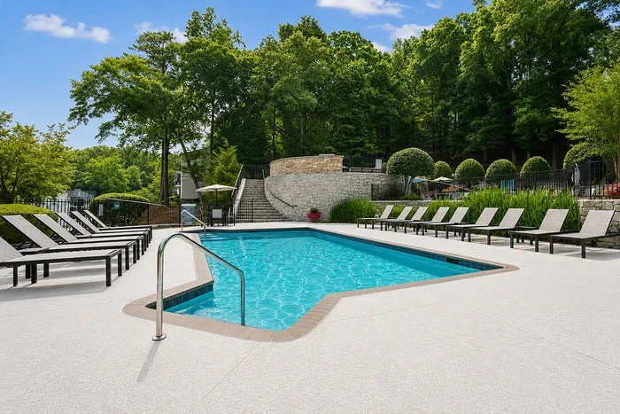 Resort-style pool with loungers at Avana Cumberland in Atlanta, GA.
