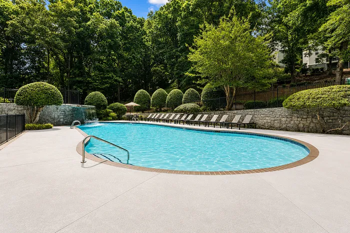 Outdoor pool with stone walls at Avana Cumberland in Atlanta, GA.