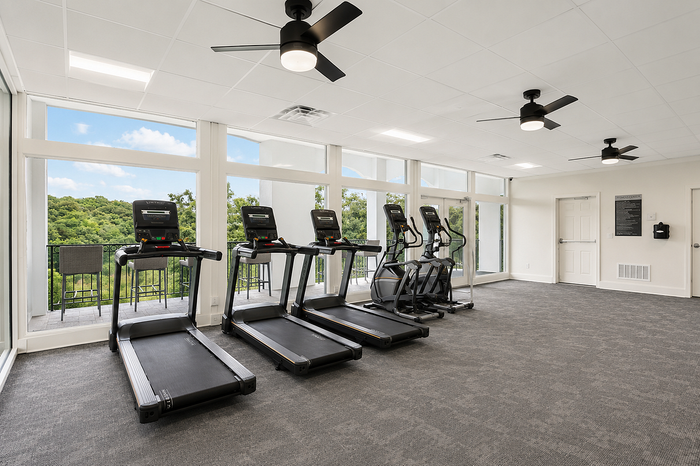 Fitness center with treadmill and stair stepper overlooking the Chattahoochee River at Avana Cumberland in Atlanta, GA.