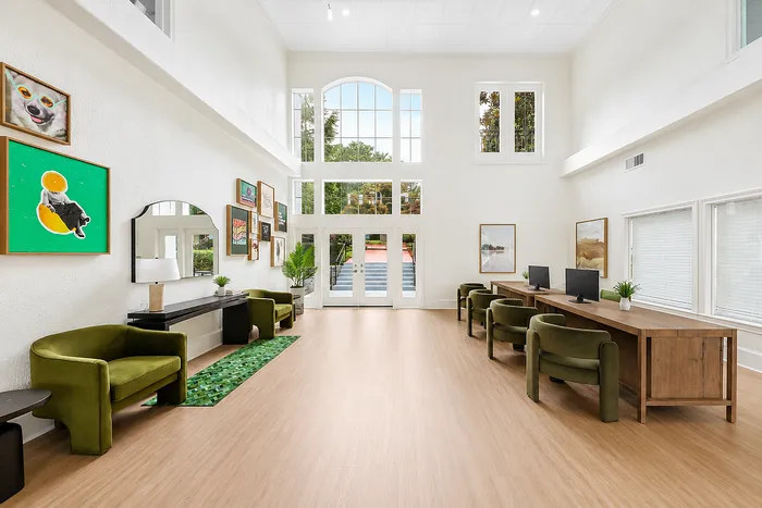 Spacious and bright communal area with high ceilings, modern decor, and ample seating, perfect for relaxation and work.