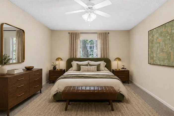 Elegant and cozy bedroom with chic decor featuring a plush green bed, stylish wooden furniture, and serene wall art.