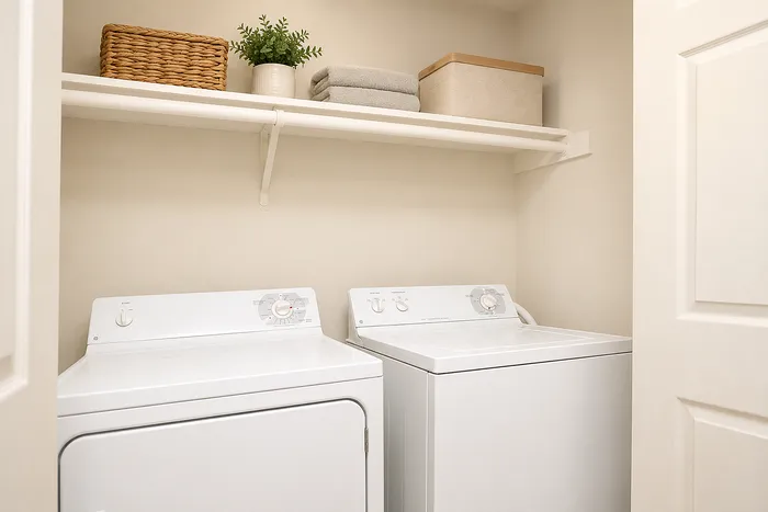Bright and efficient laundry room with modern washer and dryer, neatly organized with shelves and storage solutions.