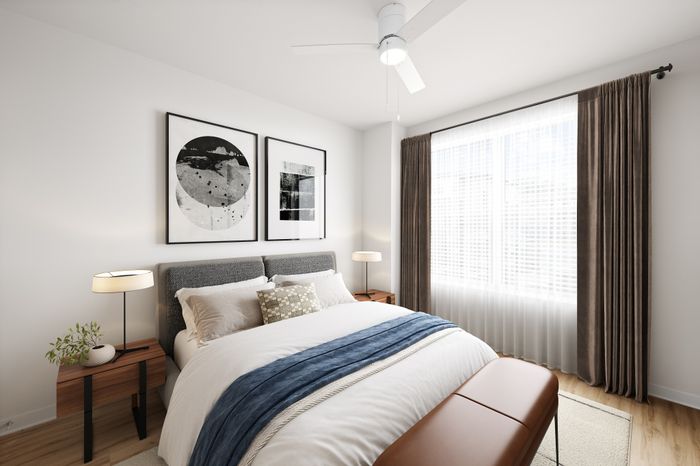 Bright and inviting bedroom featuring modern wall art, elegant decor, and abundant natural light through large windows.
