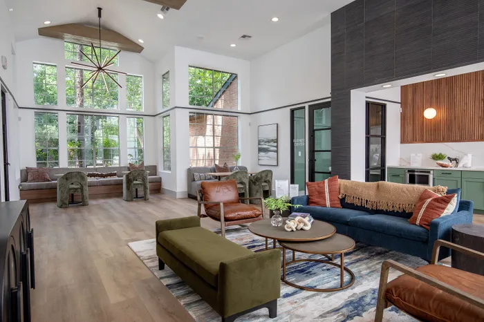 Bright and inviting lounge area with large windows, stylish seating, and modern decor, perfect for relaxation.