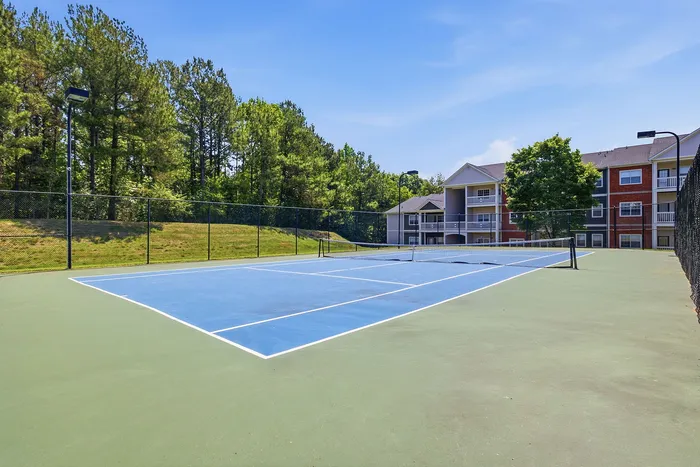 Charming residential community with scenic tennis court and lush greenery, offering modern living amenities.