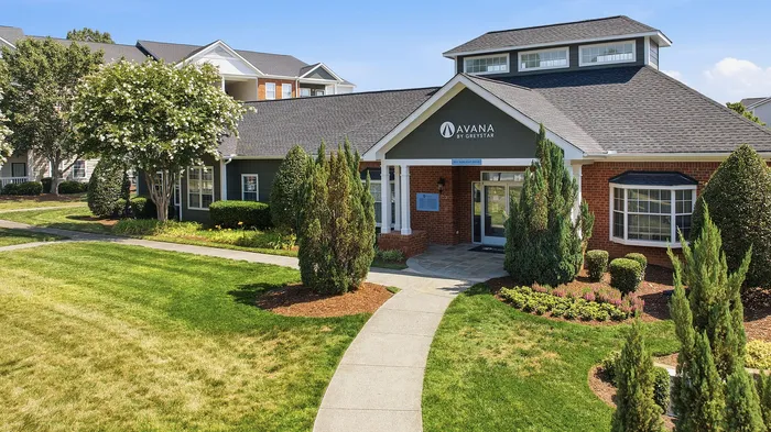 Charming residential complex showcasing beautifully landscaped greenery, modern architecture, and inviting walkways.