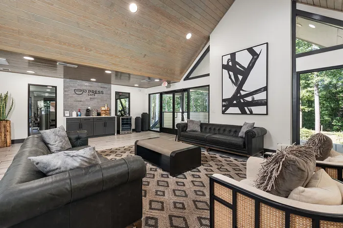 Inviting apartment lounge with elegant seating, modern decor, and a cozy cafe corner for relaxation and social gatherings.