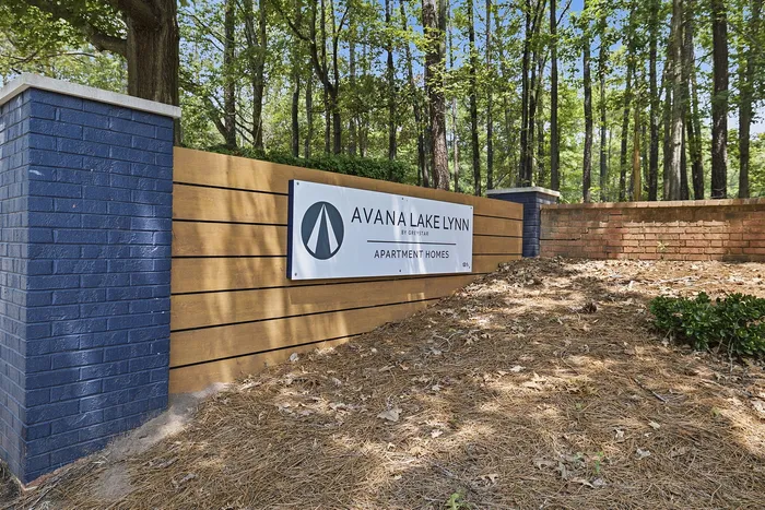 Inviting entrance at Avana Lake Lynn apartment homes surrounded by lush greenery and modern design.