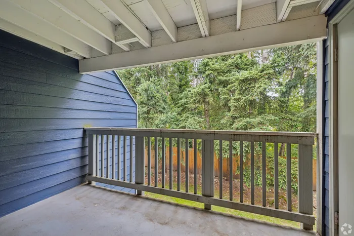 Charming balcony with serene forest views, perfect for relaxation and enjoying nature's tranquility.