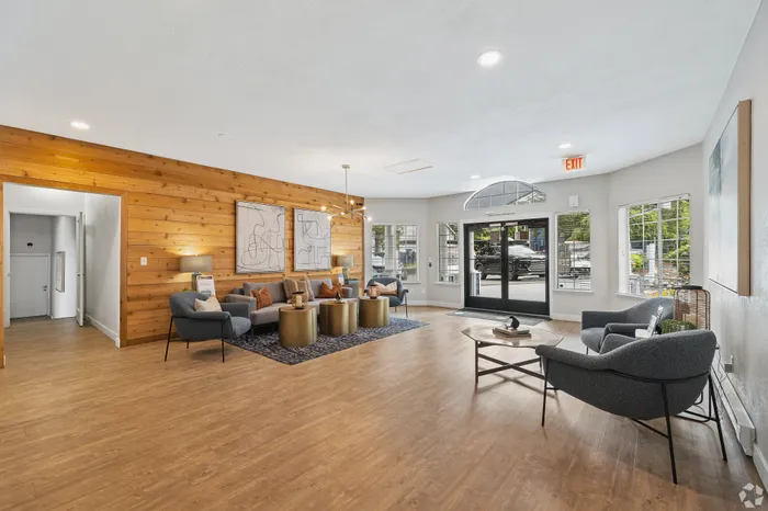 Inviting apartment lobby with elegant wood accents, modern seating, and stylish decor.