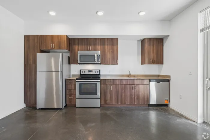 Modern kitchen with sleek stainless steel appliances and elegant wooden cabinetry, offering a perfect blend of style and functionality.