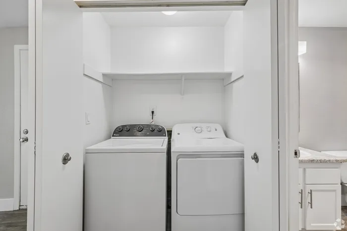 Efficient laundry nook with modern washer and dryer, enhancing apartment convenience.