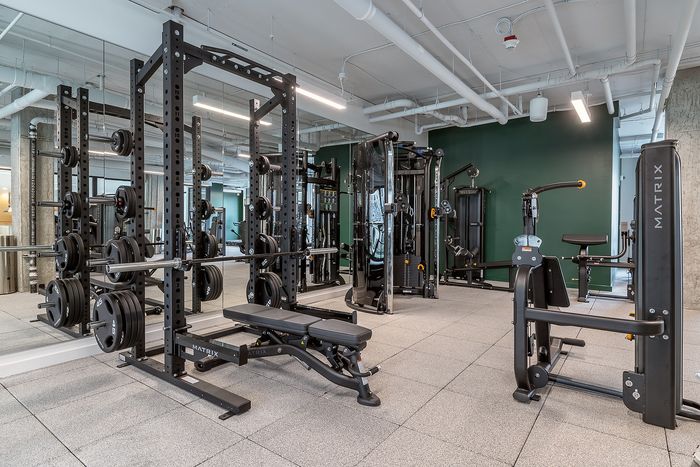 Modern apartment gym with state-of-the-art workout equipment and sleek design.