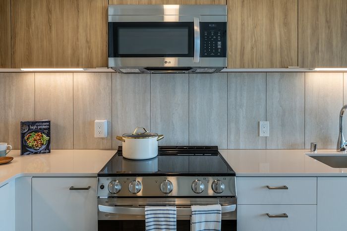 Modern kitchen with sleek stainless steel appliances, chic cabinetry, and elegant countertops, perfect for gourmet cooking.