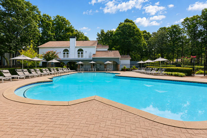 Swimming pool with landscaped surroundings and poolside seating at Avana TownPark in Kennesaw, GA