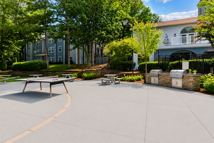 Social lawn with grilling stations and outdoor gathering space at Avana TownPark in Kennesaw, GA