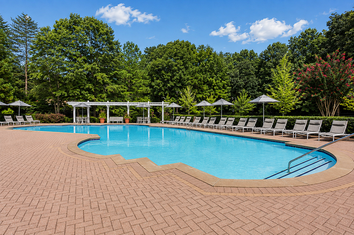 Swimming pool with poolside lounge area and landscaped surroundings at Avana TownPark in Kennesaw, GA